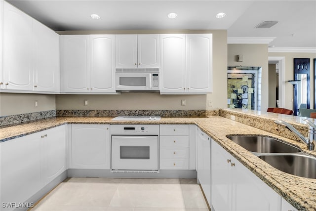 900 5th Ave S Unit 302, Naples, FL 34102 - kitchen featuring white appliances, a sink, ornamental molding, light stone countertops, and white cabinetry