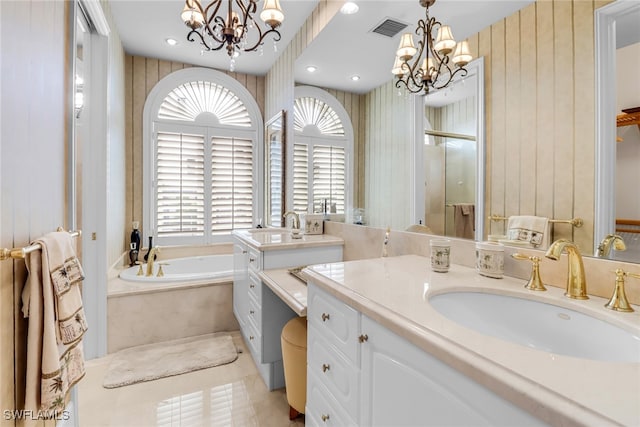 900 5th Ave S Unit 302, Naples, FL 34102 - bathroom with a chandelier, a garden tub, vanity, and a shower stall