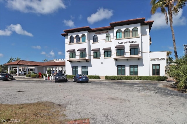 900 5th Ave S Unit 302, Naples, FL 34102 - view of building exterior featuring uncovered parking