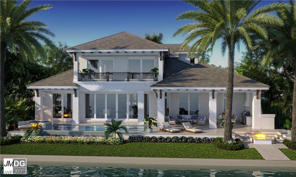 860 Banyan Ct, Marco Island, FL 34145 - back of property with a balcony, an outdoor living space with a fire pit, a patio area, and stucco siding