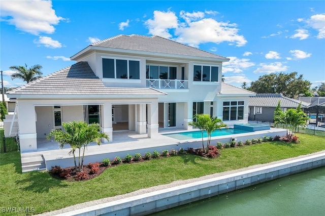 954 Sundrop Ct, Marco Island, FL 34145 - back of house with a balcony, a tiled roof, a patio, and stucco siding