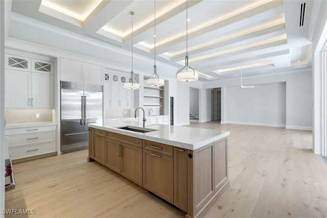 954 Sundrop Ct, Marco Island, FL 34145 - kitchen with stainless steel built in fridge, a sink, light wood-type flooring, a center island with sink, and beamed ceiling