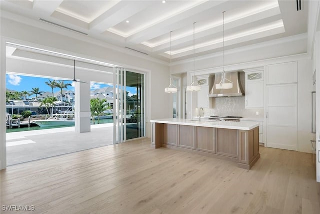 954 Sundrop Ct, Marco Island, FL 34145 - kitchen featuring wall chimney exhaust hood, light wood finished floors, decorative backsplash, beam ceiling, and light countertops