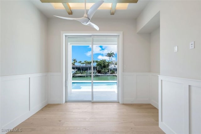 954 Sundrop Ct, Marco Island, FL 34145 - doorway with a decorative wall, light wood finished floors, and a wainscoted wall