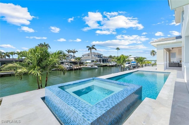 954 Sundrop Ct, Marco Island, FL 34145 - view of swimming pool featuring a water view, a patio, and a pool with connected hot tub