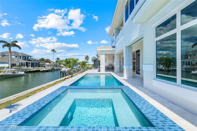 954 Sundrop Ct, Marco Island, FL 34145 - view of swimming pool with a water view, a pool with connected hot tub, and a patio