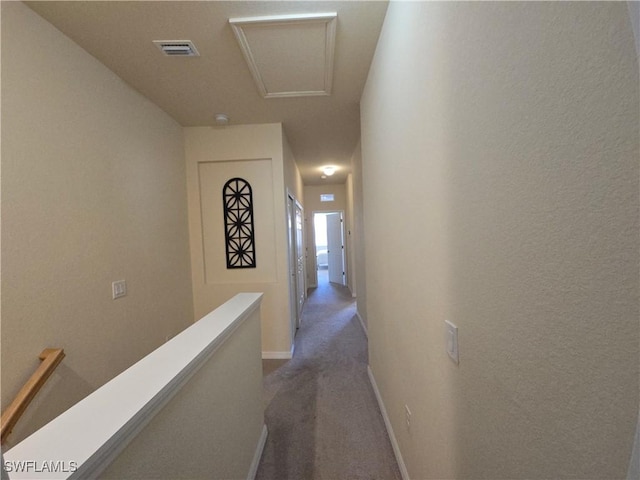 8874 Via Isola Ct, Fort Myers, FL 33966 - hallway with an upstairs landing, dark colored carpet, and attic access