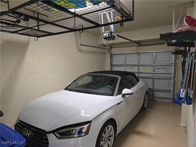 8874 Via Isola Ct, Fort Myers, FL 33966 - garage featuring a garage door opener and concrete block wall