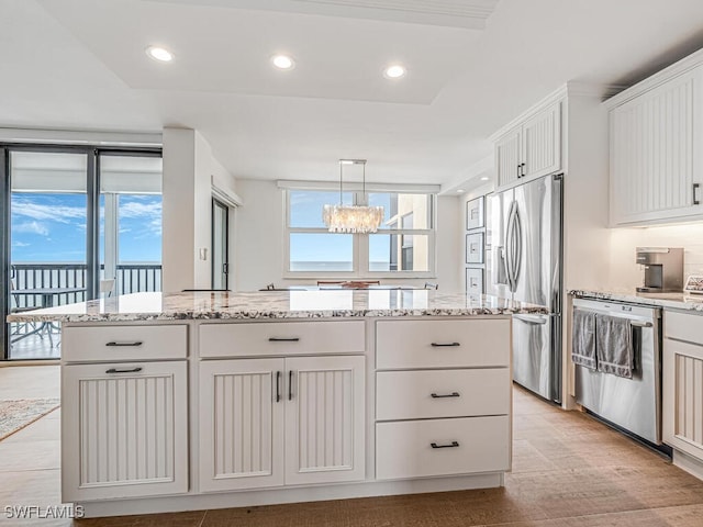 9375 Gulf Shore Dr Unit 601, Naples, FL 34108 - kitchen featuring appliances with stainless steel finishes, a chandelier, a kitchen island, plenty of natural light, and recessed lighting
