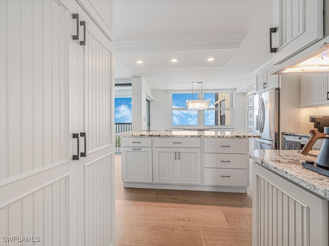 9375 Gulf Shore Dr Unit 601, Naples, FL 34108 - kitchen with freestanding refrigerator, light stone countertops, pendant lighting, recessed lighting, and light wood finished floors