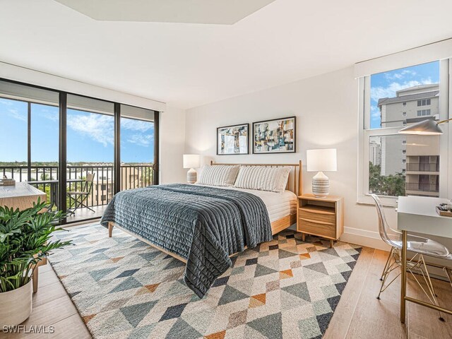 9375 Gulf Shore Dr Unit 601, Naples, FL 34108 - bedroom with wood finished floors, access to outside, and baseboards