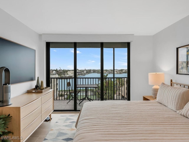 9375 Gulf Shore Dr Unit 601, Naples, FL 34108 - bedroom with access to exterior, a water view, and light wood-style flooring