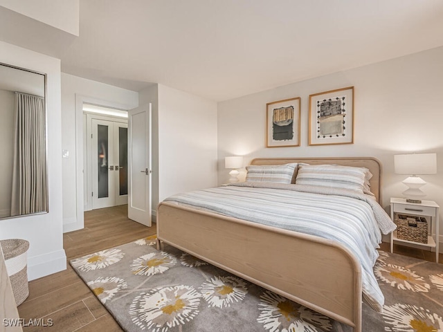 9375 Gulf Shore Dr Unit 601, Naples, FL 34108 - bedroom with wood finished floors, baseboards, and french doors