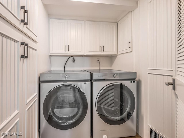 9375 Gulf Shore Dr Unit 601, Naples, FL 34108 - laundry room featuring washing machine and dryer and cabinet space