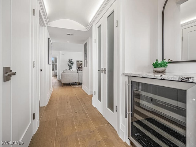 9375 Gulf Shore Dr Unit 601, Naples, FL 34108 - hallway with wine cooler, lofted ceiling, light wood-style floors, and baseboards