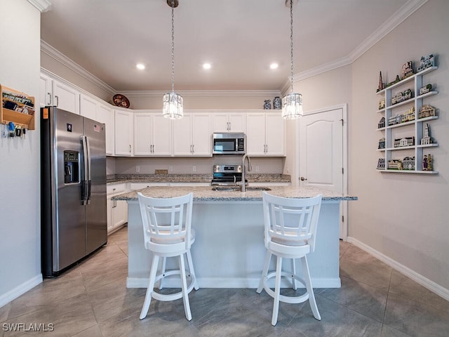 2174 Clementine St, Naples, FL 34120 - kitchen with appliances with stainless steel finishes, a sink, white cabinets, ornamental molding, and a kitchen breakfast bar