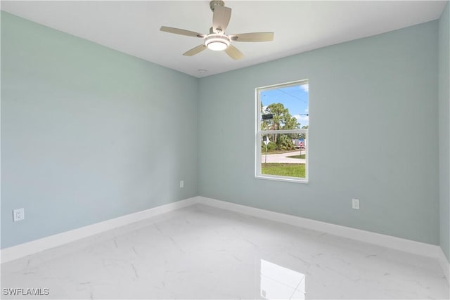 3113 68th St W, Lehigh Acres, FL 33971 - unfurnished room featuring marble finish floors, baseboards, and a ceiling fan