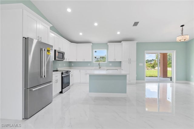 3113 68th St W, Lehigh Acres, FL 33971 - kitchen with stainless steel appliances, a sink, light countertops, white cabinets, and recessed lighting