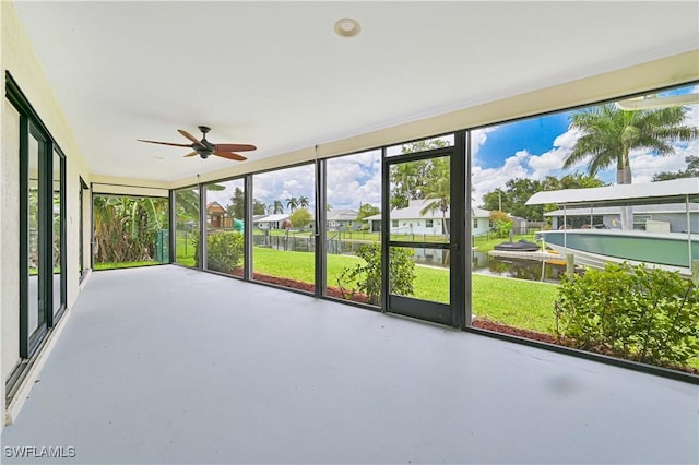 14938 Randolph Dr, Fort Myers, FL 33905 - unfurnished sunroom featuring a ceiling fan, a water view, and healthy amount of natural light