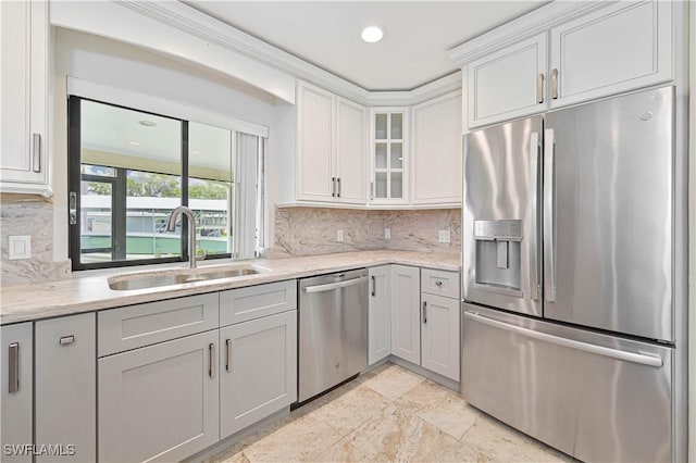 14938 Randolph Dr, Fort Myers, FL 33905 - kitchen with appliances with stainless steel finishes, a sink, glass insert cabinets, decorative backsplash, and white cabinets
