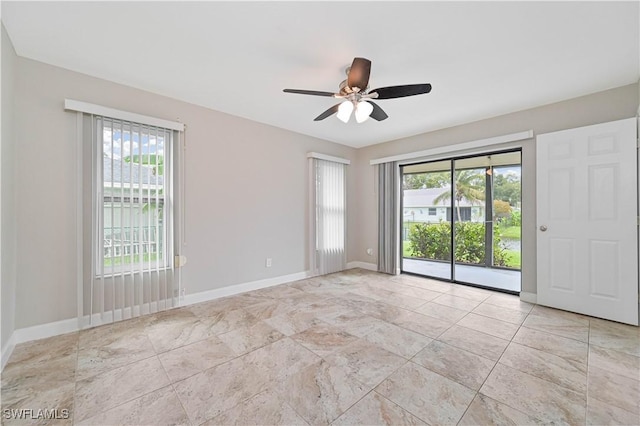 14938 Randolph Dr, Fort Myers, FL 33905 - spare room featuring healthy amount of natural light, ceiling fan, and baseboards