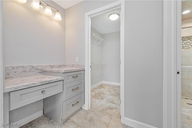 14938 Randolph Dr, Fort Myers, FL 33905 - full bathroom with a walk in closet, vanity, and baseboards