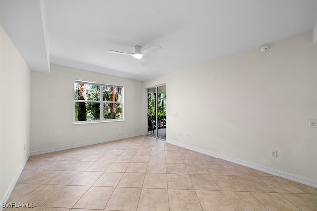 1630 Tarpon Bay Dr S Unit 102, Naples, FL 34119 - unfurnished room with ceiling fan, light tile patterned floors, a smoke detector, and baseboards