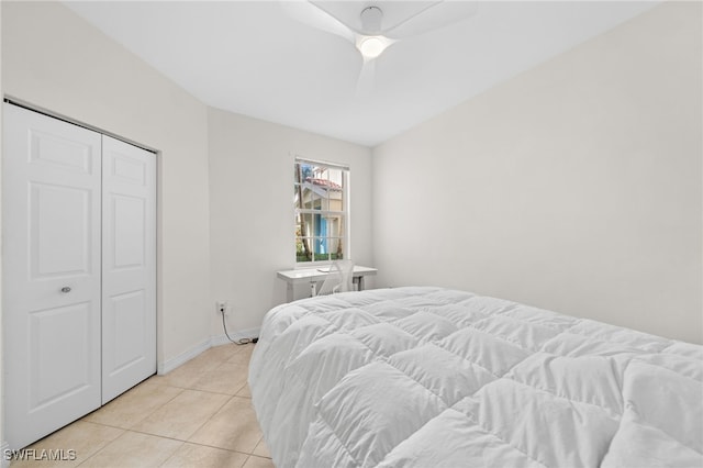 1630 Tarpon Bay Dr S Unit 102, Naples, FL 34119 - bedroom with light tile patterned flooring, baseboards, a ceiling fan, and a closet