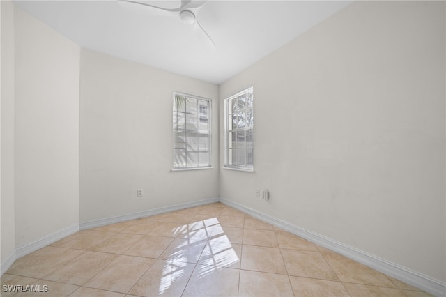 1630 Tarpon Bay Dr S Unit 102, Naples, FL 34119 - empty room with tile patterned flooring, a ceiling fan, and baseboards