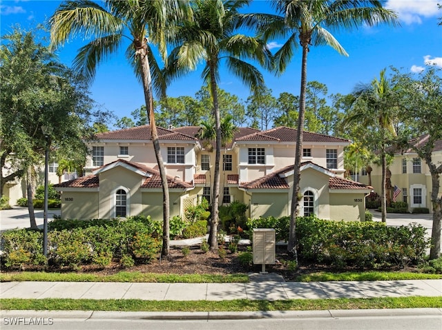 1630 Tarpon Bay Dr S Unit 102, Naples, FL 34119 - mediterranean / spanish home with a tile roof and stucco siding