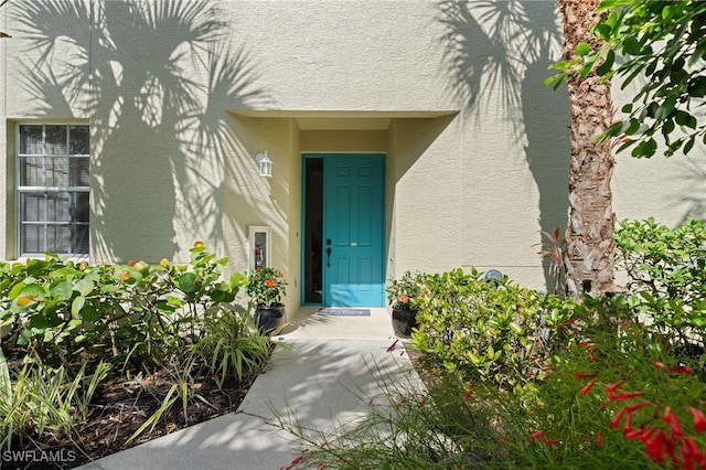 1630 Tarpon Bay Dr S Unit 102, Naples, FL 34119 - doorway to property with stucco siding