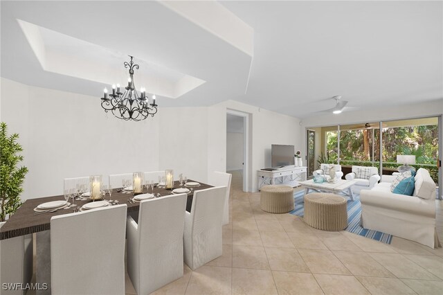 1630 Tarpon Bay Dr S Unit 102, Naples, FL 34119 - dining space featuring a chandelier, light tile patterned floors, and a raised ceiling