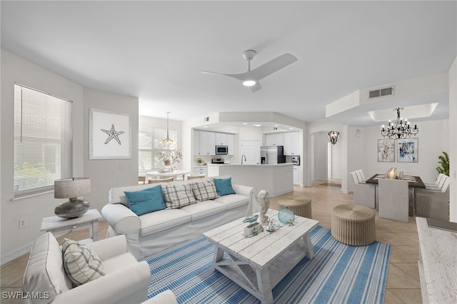 1630 Tarpon Bay Dr S Unit 102, Naples, FL 34119 - living area featuring a chandelier, ceiling fan, light tile patterned floors, and healthy amount of natural light
