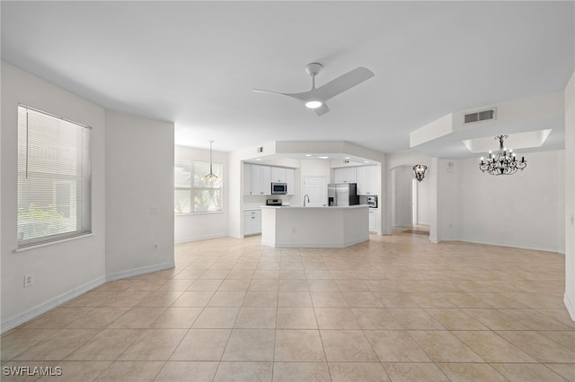 1630 Tarpon Bay Dr S Unit 102, Naples, FL 34119 - unfurnished living room featuring ceiling fan, a chandelier, light tile patterned flooring, and baseboards
