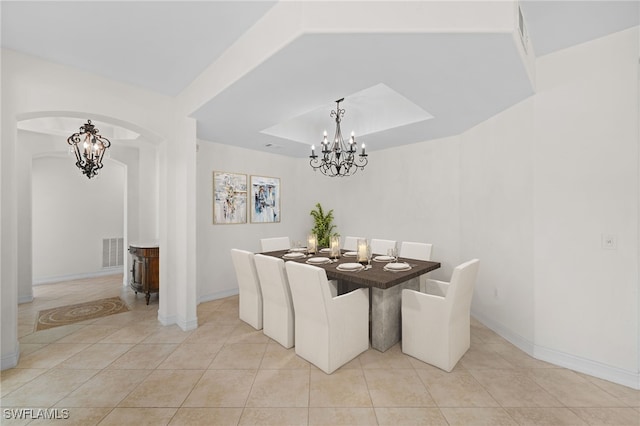 1630 Tarpon Bay Dr S Unit 102, Naples, FL 34119 - dining room with arched walkways, light tile patterned flooring, a chandelier, and baseboards