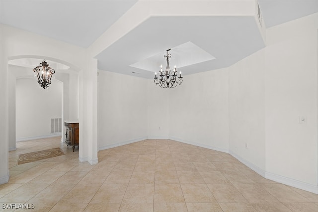 1630 Tarpon Bay Dr S Unit 102, Naples, FL 34119 - tiled empty room with arched walkways, a chandelier, and baseboards
