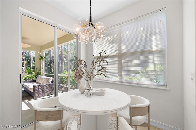 1630 Tarpon Bay Dr S Unit 102, Naples, FL 34119 - dining room with baseboards and a chandelier