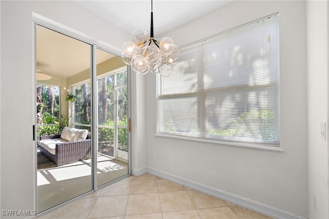 1630 Tarpon Bay Dr S Unit 102, Naples, FL 34119 - tiled dining room with baseboards, healthy amount of natural light, and a chandelier