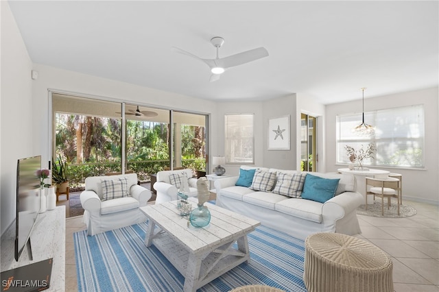 1630 Tarpon Bay Dr S Unit 102, Naples, FL 34119 - living room with light tile patterned floors, a ceiling fan, plenty of natural light, and baseboards