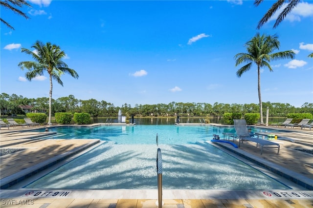 1630 Tarpon Bay Dr S Unit 102, Naples, FL 34119 - community pool with a patio area and view of scattered trees