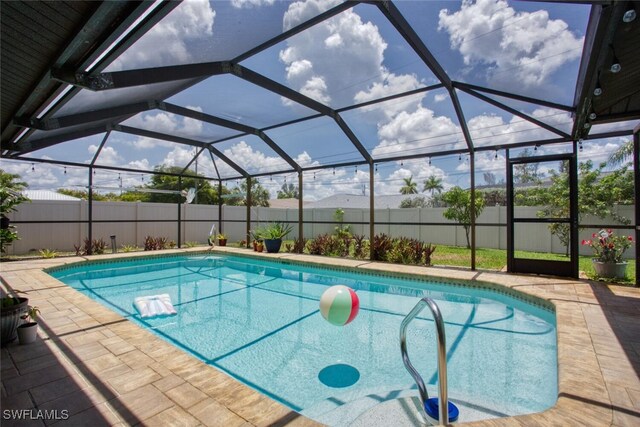 1918 NE 3rd St, Cape Coral, FL 33909 - view of swimming pool featuring a fenced backyard, a patio area, and a lanai