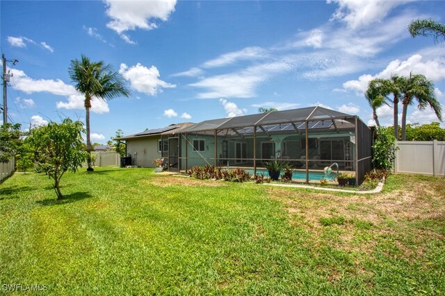 1918 NE 3rd St, Cape Coral, FL 33909 - rear view of property with glass enclosure and an outdoor pool