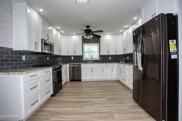 1918 NE 3rd St, Cape Coral, FL 33909 - kitchen featuring black appliances, a sink, a ceiling fan, white cabinets, and recessed lighting