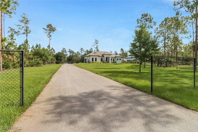 2909 2nd Ave NE, Naples, FL 34120 - view of asphalt driveway featuring a gated entry
