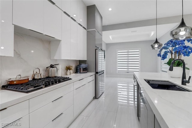 2909 2nd Ave NE, Naples, FL 34120 - kitchen featuring a sink, modern cabinets, black gas stovetop, white cabinetry, and recessed lighting