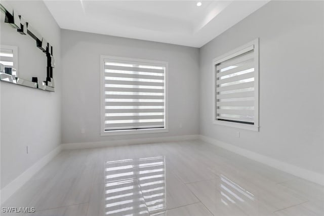 2909 2nd Ave NE, Naples, FL 34120 - tiled spare room with healthy amount of natural light and baseboards