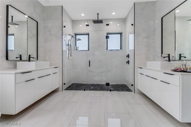 2909 2nd Ave NE, Naples, FL 34120 - full bath with a shower stall, healthy amount of natural light, and two vanities