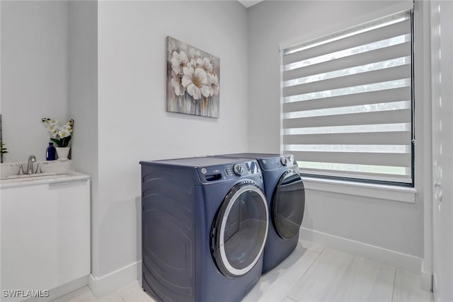 2909 2nd Ave NE, Naples, FL 34120 - washroom with independent washer and dryer, baseboards, plenty of natural light, and light tile patterned floors