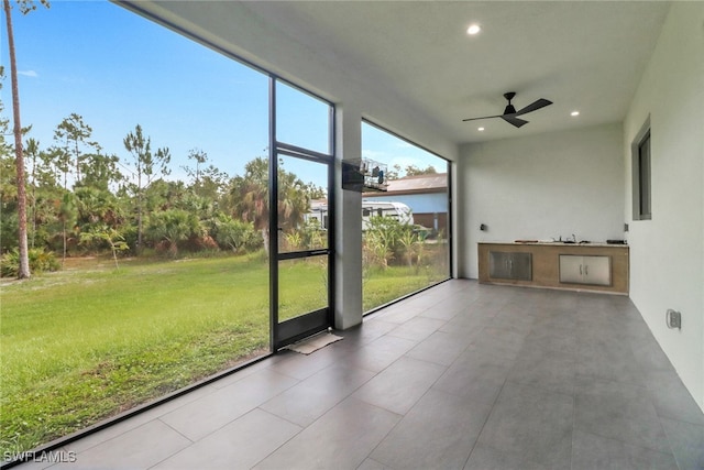 2909 2nd Ave NE, Naples, FL 34120 - unfurnished sunroom featuring ceiling fan