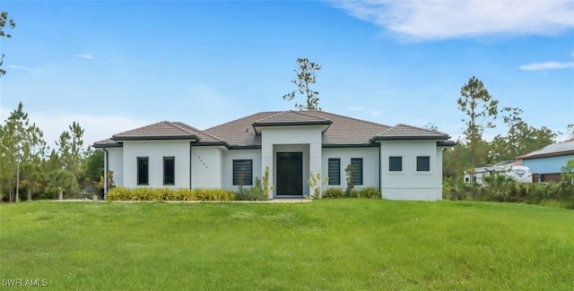 2909 2nd Ave NE, Naples, FL 34120 - contemporary home with a front lawn, stucco siding, and a tiled roof